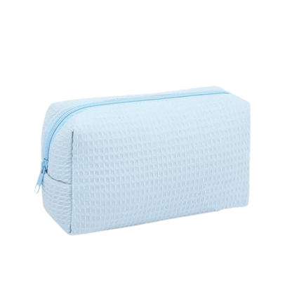 A light blue textured zippered pouch with a waffle-weave pattern, shown on a plain white background.
